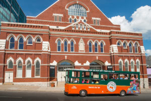 old town trolley tour vehicle in front of ryman auditorium in nashville