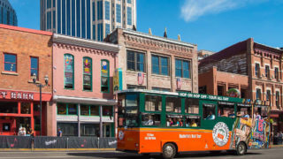 old town trolley tour driving down broadway street during nashville tour