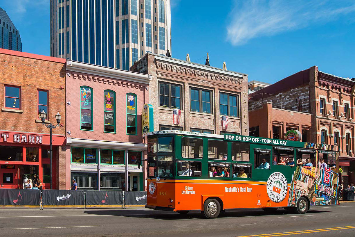 old town trolley tour driving down broadway street during nashville tour