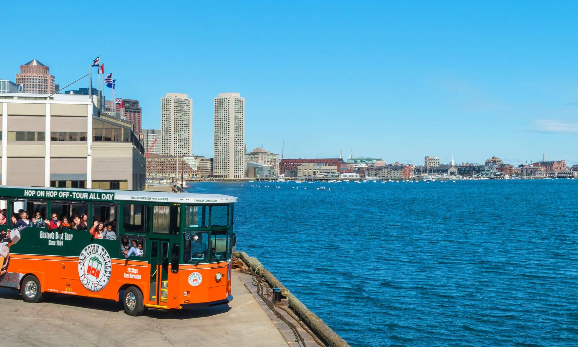 Old Town Trolley parked at the edge of the Boston Harbor