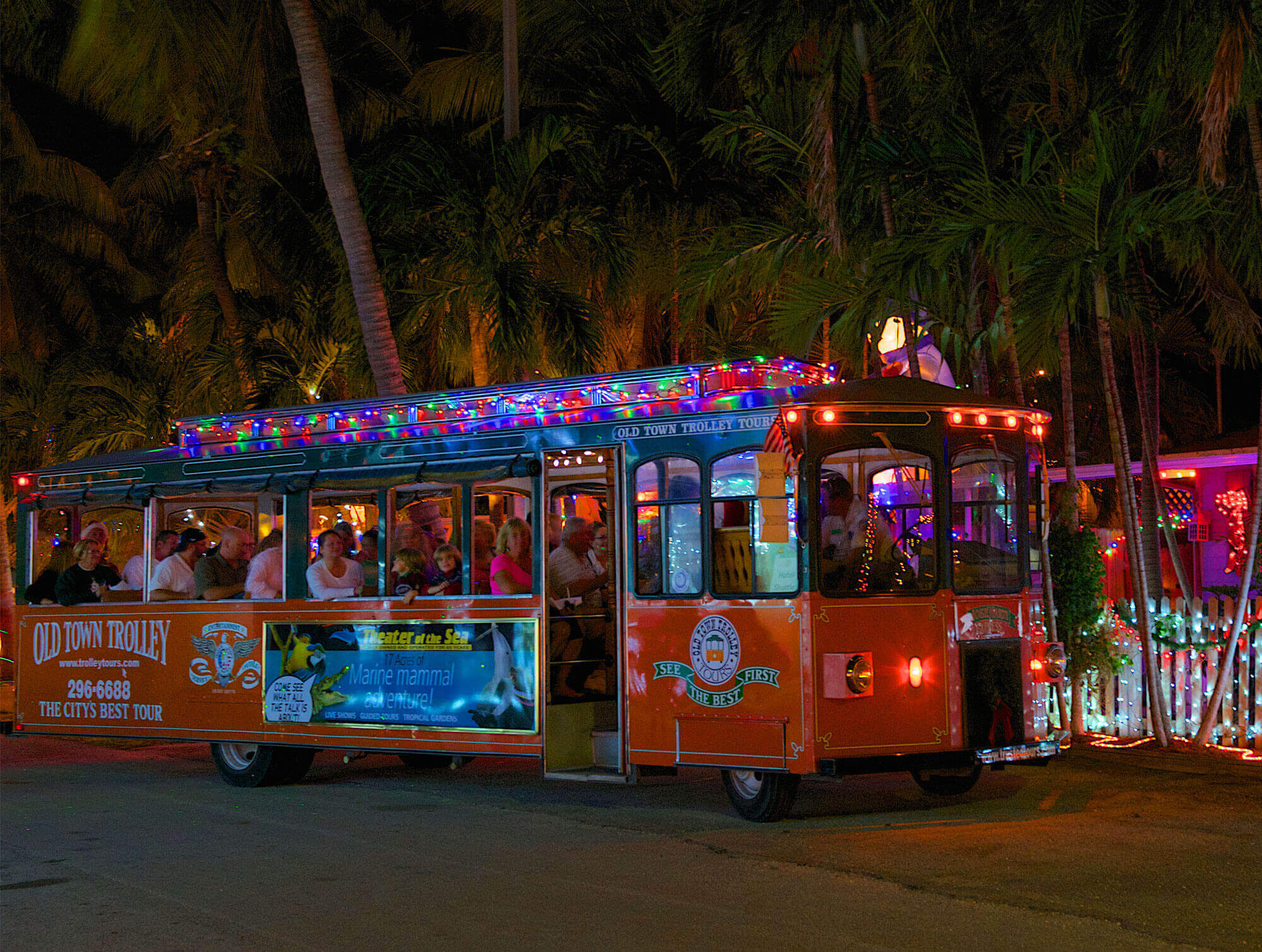 An Old Town Trolley decorated in lights on a Holiday Sights & Festive Nights Tour in Key West, FL