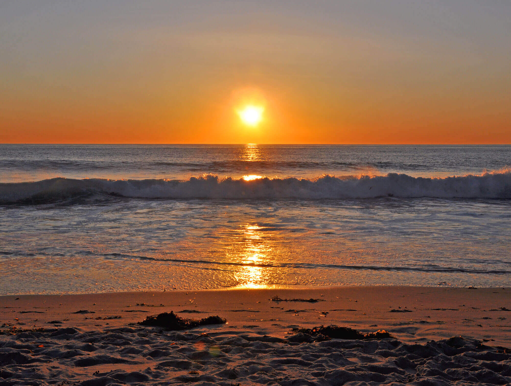 Beautiful sunset on the horizon from a beach in San Diego, CA