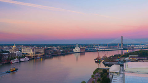 A view of the Savannah River at dusk with the Talmadge Memorial Bridge in the background