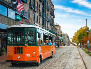 exterior of old town trolley vehicle with visitors to savannah ga