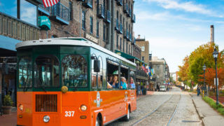 Hop On Hop Off Savannah - exterior of old town trolley vehicle with visitors to savannah ga