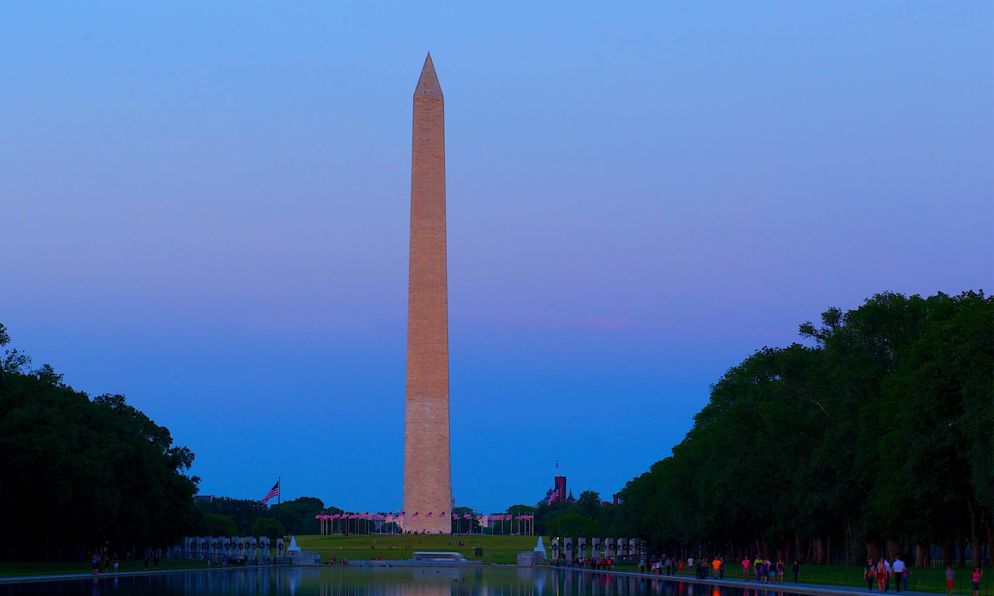 Head on view of the Washington Monument across the Reflecting Pool in Washington DC at night