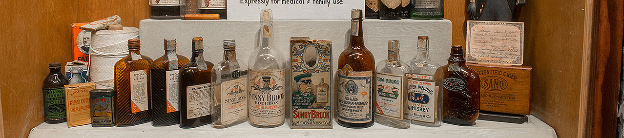 a row of medicinal whiskey bottles on display