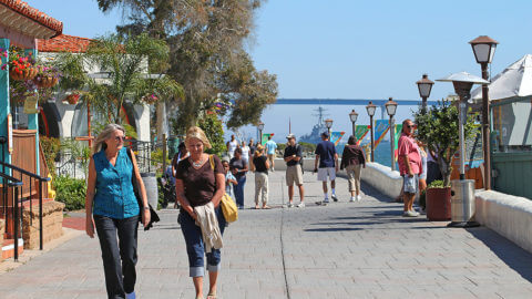 tourists social distancing on downtown seaport village boardwalk in san diego