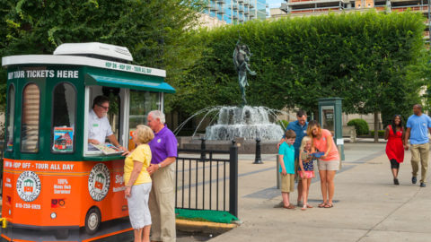 Families in the vicinity of an Old Town Trolley Tours ticket booth in Nashville, TN