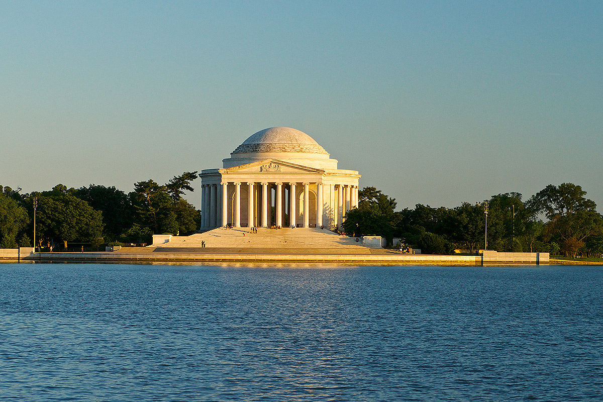 view of Jefferson Memorial made up of a dome and columns sitting on the tidal basin in Washington DC