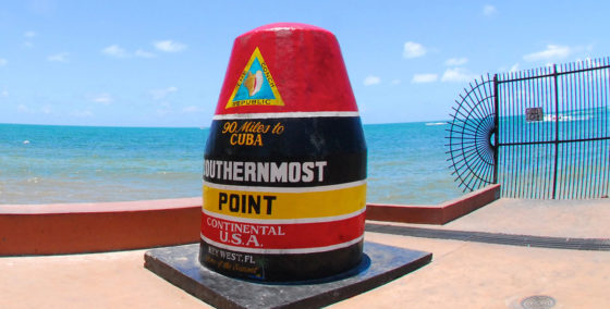 image of southernmost point landmark in front of the water