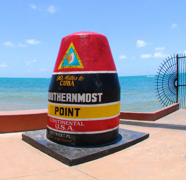 image of southernmost point landmark in front of the water