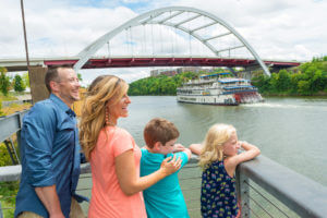 parents and two children enjoying view of water at nashville riverfront park