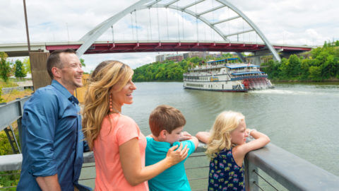 parents and two children enjoying view of water at nashville riverfront park