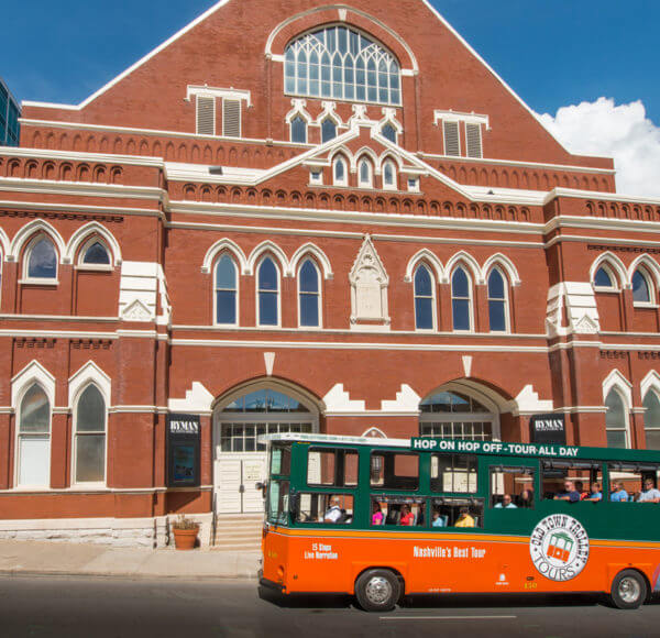 old town trolley tour vehicle in front of ryman auditorium in nashville