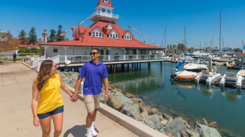 Couple walking along San Diego harbor