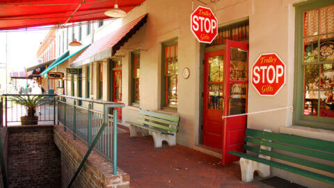 facade of savannah gift shop with signs that read 'Trolley Stop Gifts'