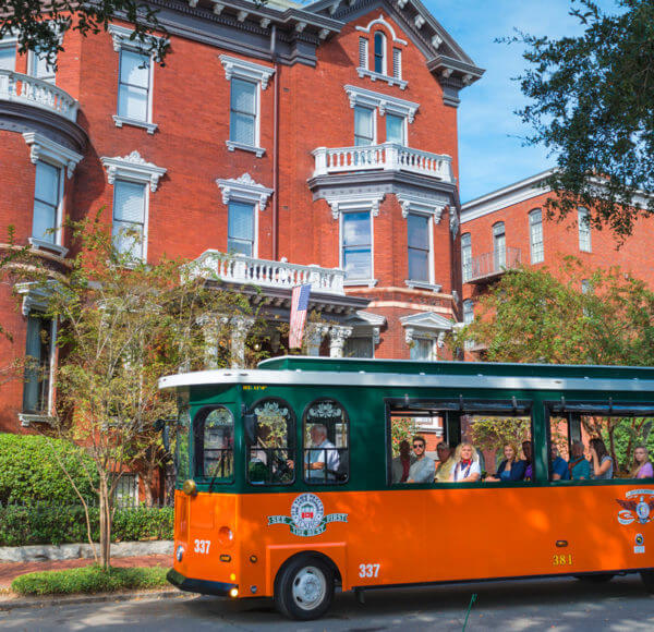 old town trolley savannah vehicle in front of kehoe house in savannah