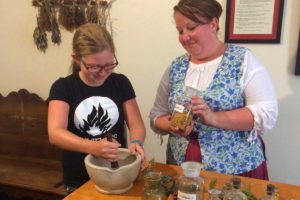 child learning to make herb medicine at spanish military hospital st augustine