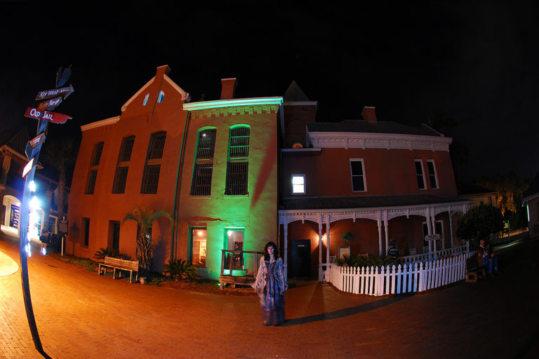 night time picture of ghost host standing in front of St. Augustine's Old Jail