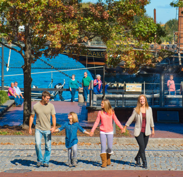 Family walking along River Street in Savannah
