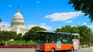 old town trolley in Washington DC driving past US Capitol building