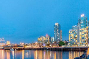 view of exterior of wyndham san diego hotel bayside from water at night