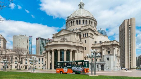 Outside the Christian Science Plaza in Boston where can be seen an Old Town Trolley in front of the Mother Church