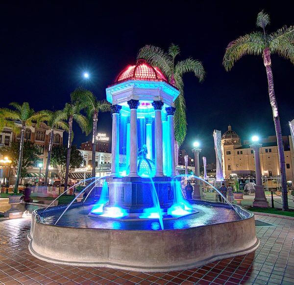 The very ornate illuminated Broadway fountain built on Roman style columns across the street from the U.S. Grant Hotel In San Diego
