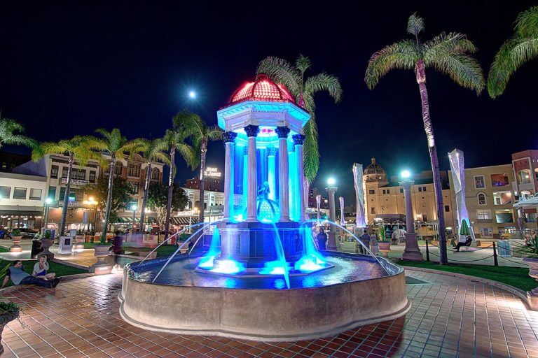 The very ornate illuminated Broadway fountain built on Roman style columns across the street from the U.S. Grant Hotel In San Diego