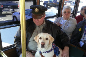 veteran and service dog on san diego trolley tour