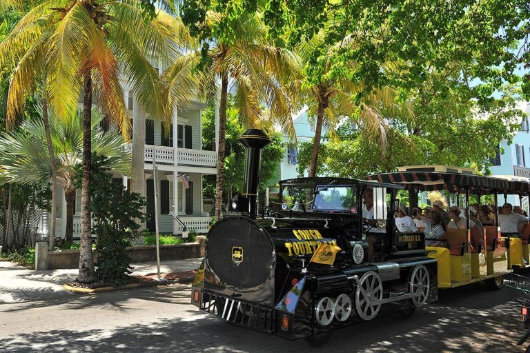 conch tour train driving past key west house