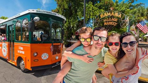 Family standing next to Key West trolley