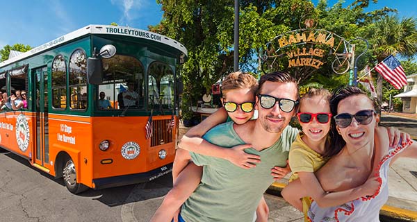 Family standing next to Key West trolley