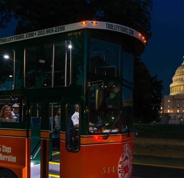 Old Town Trolley passing by the US capitol in Washington DC at night