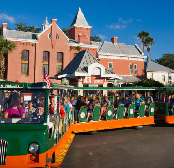 Old Town Trolley driving past the grounds of St. Augustine Old Jail and Gator Bob's Trading Post