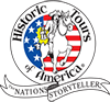Historic Tours of America Logo that is round. Inside the circle are stars and stripes and over those, an illustration of a horse being ridden by Paul Revere holding a lantern. Around logo are the words 'Historic Tours of America' and 'The Nation's Storyteller'.