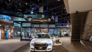 National Law Enforcement Museum - national law enforcement museum exhibit featuring a police car in the center with a door open and the words 'Indiana State Police' and in the background, glass case with a truck mounted on the top