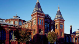 Smithsonian Museum Guide To DC - exterior picture of Washington DC arts & Industries building made of bricks, multiple windows and two towers