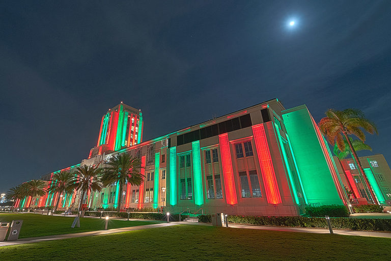 San Diego building lit up in green and red holiday lights