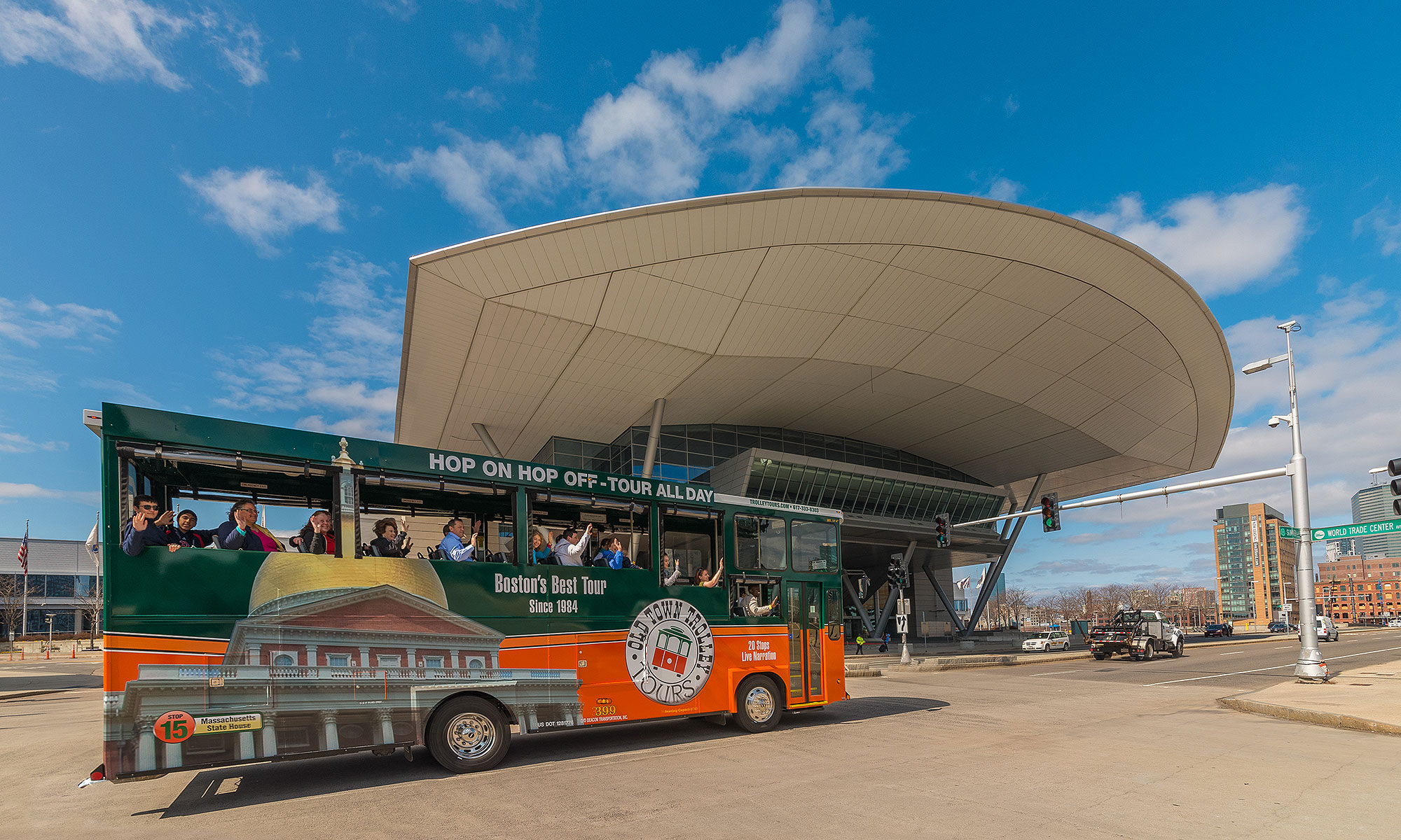 boston old town trolley driving past convention center with a large overhang