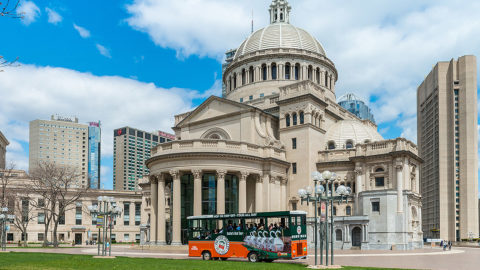 Boston trolley driving past Christian Science Plaza complete with a dome