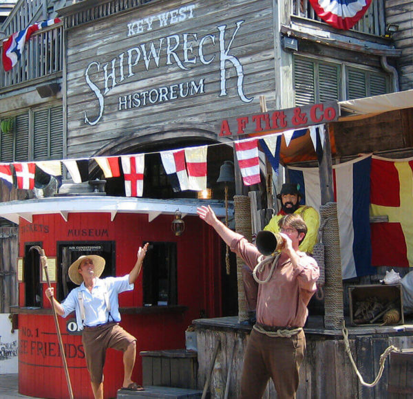 Tour guides outside the Key West Shipwreck Museum