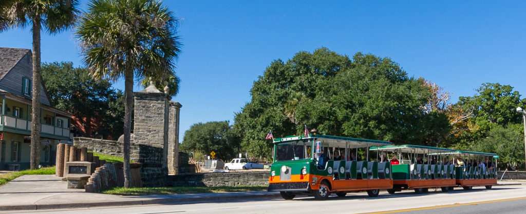 St. Augustine trolley driving past old city gates