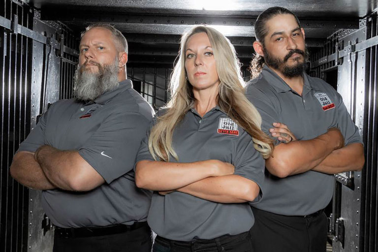 three tour guides standing inside St. Augustine Old Jail