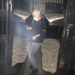 lady at old jail after dark holding a ghost hunting tool