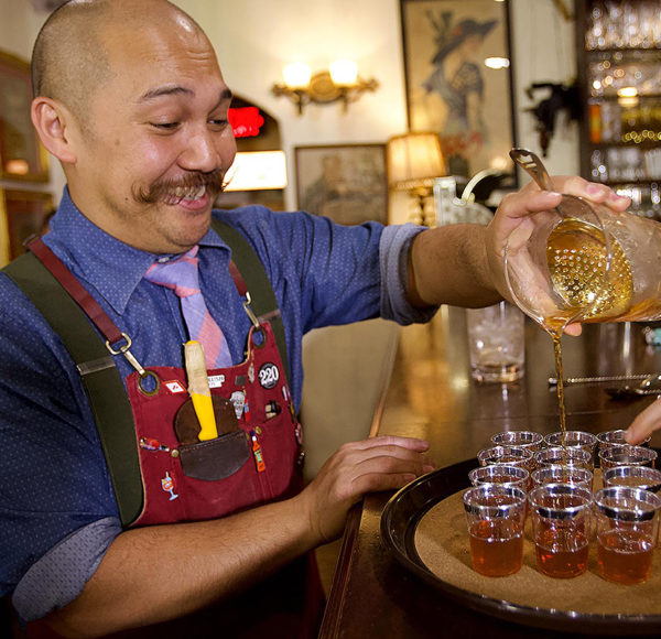 Bartender pouring whiskey at American Prohibition Museum