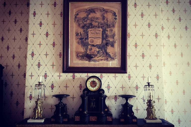 Whaley House interior space featuring a mantel and framed artwork