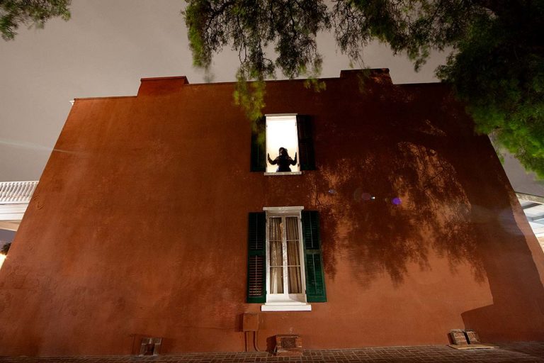 Whaley House windows and tour guide at night