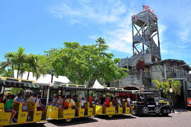 A full Conch Tour Train waiting outside the Shipwreck Museum in Key West, FL